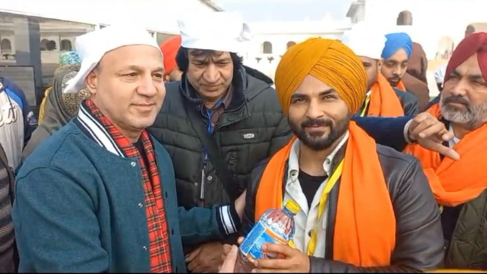 Yatrees receiving Amrit Jal at Kartarpur Sahib as an act of Seva